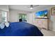 This spacious main bedroom includes a ceiling fan, large TV and sliding door access to the screened lanai at 7448 S Blue Sage, Punta Gorda, FL 33955