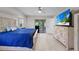 This spacious main bedroom includes a ceiling fan, large TV and sliding door access to the screened lanai at 7448 S Blue Sage, Punta Gorda, FL 33955