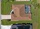 Aerial view of the property showing the brown roof, pool and landscaping at 85 Long Meadow Ct, Rotonda West, FL 33947