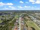 Expansive aerial view of the community featuring lush landscaping and a nearby golf course and waterways at 85 Long Meadow Ct, Rotonda West, FL 33947
