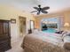 Bedroom featuring a ceiling fan and a sliding glass door providing a view of the pool at 85 Long Meadow Ct, Rotonda West, FL 33947
