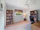 Bedroom featuring bookshelves, a ceiling fan, and a window for natural light at 85 Long Meadow Ct, Rotonda West, FL 33947