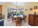 Bright dining area featuring rattan chairs, decorative light fixture, and sliding glass doors to the outdoor living space at 85 Long Meadow Ct, Rotonda West, FL 33947