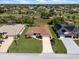 Aerial view of a charming single-story home boasting lush landscaping and a long driveway at 85 Long Meadow Ct, Rotonda West, FL 33947