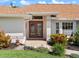 Inviting front entrance showcasing double doors, manicured landscaping, and a well-maintained walkway at 85 Long Meadow Ct, Rotonda West, FL 33947