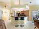 Open kitchen with breakfast bar, stainless steel appliances, and ample counter space at 85 Long Meadow Ct, Rotonda West, FL 33947