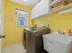 Laundry room equipped with a washer, dryer, utility sink, and storage cabinets at 85 Long Meadow Ct, Rotonda West, FL 33947