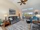 Cozy living room featuring comfortable sofas, a ceiling fan, and sliding glass doors leading to the outdoor space at 85 Long Meadow Ct, Rotonda West, FL 33947