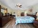 Bright main bedroom with a ceiling fan, hardwood floors, king bed, and a spacious layout at 85 Long Meadow Ct, Rotonda West, FL 33947