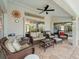 Covered patio boasts comfortable wicker furniture, perfect for outdoor relaxation at 85 Long Meadow Ct, Rotonda West, FL 33947