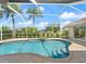 Beautiful screened pool and spa provides a tropical view with palm trees at 85 Long Meadow Ct, Rotonda West, FL 33947