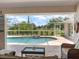 Screened in pool area with seating and a view of the lush backyard landscaping at 85 Long Meadow Ct, Rotonda West, FL 33947