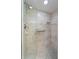 Modern tile shower featuring a glass enclosure, grab bar, and a built-in niche at 85 Long Meadow Ct, Rotonda West, FL 33947