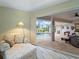 Cozy sitting area with comfortable seating, a lamp, and sliding glass doors leading to the outdoor pool area at 85 Long Meadow Ct, Rotonda West, FL 33947