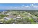 Aerial view of an estate home with a golf course in the background at 10161 Eagle Preserve Dr, Englewood, FL 34224