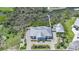 Expansive home with manicured lawn, private dock with boat lift, lush landscaping, and a circular driveway at 10161 Eagle Preserve Dr, Englewood, FL 34224