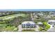 Aerial view of an estate home with a lush surrounding, a golf course, and canal access at 10161 Eagle Preserve Dr, Englewood, FL 34224