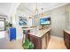 Wet bar features stone countertops, beverage fridge, wine rack, and TV at 10161 Eagle Preserve Dr, Englewood, FL 34224