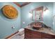 Unique powder room with a stone sink, decorative vanity and a modern accent wall design at 10161 Eagle Preserve Dr, Englewood, FL 34224