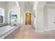 Bright bathroom showcasing granite counters, tiled floors, tub, and a unique mural accent wall at 10161 Eagle Preserve Dr, Englewood, FL 34224