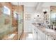 Modern bathroom with granite countertops, double sinks, and a tiled walk-in shower at 10161 Eagle Preserve Dr, Englewood, FL 34224