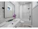 Modern bathroom with white countertop, tile shower, modern finishes and decor at 10161 Eagle Preserve Dr, Englewood, FL 34224