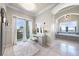 Bright vanity area with makeup mirror, fluffy stool, and balcony access at 10161 Eagle Preserve Dr, Englewood, FL 34224