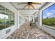 Spacious covered patio with brick flooring, ceiling fans, and comfortable seating arrangements at 10161 Eagle Preserve Dr, Englewood, FL 34224