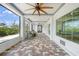Expansive covered patio boasting brick flooring, ceiling fans, and panoramic outdoor views at 10161 Eagle Preserve Dr, Englewood, FL 34224