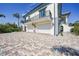 Elegant two-story home featuring a private balcony, multiple garages and brick paved driveway at 10161 Eagle Preserve Dr, Englewood, FL 34224