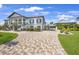 Beautiful two-story home with brick driveway and lush landscaping at 10161 Eagle Preserve Dr, Englewood, FL 34224