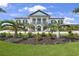 Beautiful home with columns and a well-manicured front yard at 10161 Eagle Preserve Dr, Englewood, FL 34224