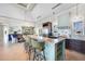 Open-concept kitchen features an island with seating, stainless steel appliances, and eat in dining at 10161 Eagle Preserve Dr, Englewood, FL 34224
