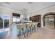 Spacious kitchen featuring an island with seating, custom cabinetry, and stainless steel appliances at 10161 Eagle Preserve Dr, Englewood, FL 34224