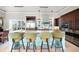 Gourmet kitchen island with seating, marble countertops, custom cabinets, and modern stainless appliances at 10161 Eagle Preserve Dr, Englewood, FL 34224