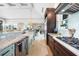 Elegant kitchen with custom cabinets, stainless steel appliances, granite countertops, and a farmhouse sink at 10161 Eagle Preserve Dr, Englewood, FL 34224