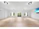 Open and airy living room filled with natural light, tiled floors, and access to the backyard at 10161 Eagle Preserve Dr, Englewood, FL 34224