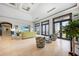 Spacious living room with stone floors, large windows, and sleek entertainment center at 10161 Eagle Preserve Dr, Englewood, FL 34224