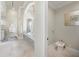 Spacious bathroom featuring large tub, granite counters, and separate toilet room at 10161 Eagle Preserve Dr, Englewood, FL 34224