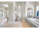 Elegant main bathroom with soaking tub, granite counters, and walk-in shower at 10161 Eagle Preserve Dr, Englewood, FL 34224