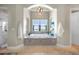 Luxurious main bathroom features a soaking tub with granite counters and an arched ceiling at 10161 Eagle Preserve Dr, Englewood, FL 34224