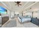Comfortable main bedroom features tray ceilings, and a ceiling fan above a king size bed at 10161 Eagle Preserve Dr, Englewood, FL 34224