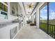 Expansive patio with a full outdoor kitchen, dining area, and views of the lush surroundings at 10161 Eagle Preserve Dr, Englewood, FL 34224