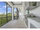 Outdoor kitchen on screened patio with built-in grill and countertop space perfect for entertaining at 10161 Eagle Preserve Dr, Englewood, FL 34224