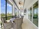 Inviting screened patio with comfortable seating, ceiling fans, and lovely outdoor views at 10161 Eagle Preserve Dr, Englewood, FL 34224