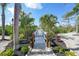 A decorative paver walkway with landscaping leads to a wooden bridge at 10161 Eagle Preserve Dr, Englewood, FL 34224