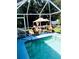 Inviting screened-in pool area with patio furniture, creating a perfect outdoor oasis at 1017 Guild St, Port Charlotte, FL 33952
