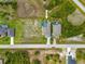 An aerial view of a home with a screened in pool, surrounded by lush landscaping at 111 Britt Rd, Rotonda West, FL 33947