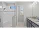 Bathroom with double sinks, stone counters, and a glass enclosed shower with built-in bench at 111 Britt Rd, Rotonda West, FL 33947