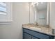 Stylish bathroom vanity featuring granite countertop and modern fixtures, next to a window at 111 Britt Rd, Rotonda West, FL 33947